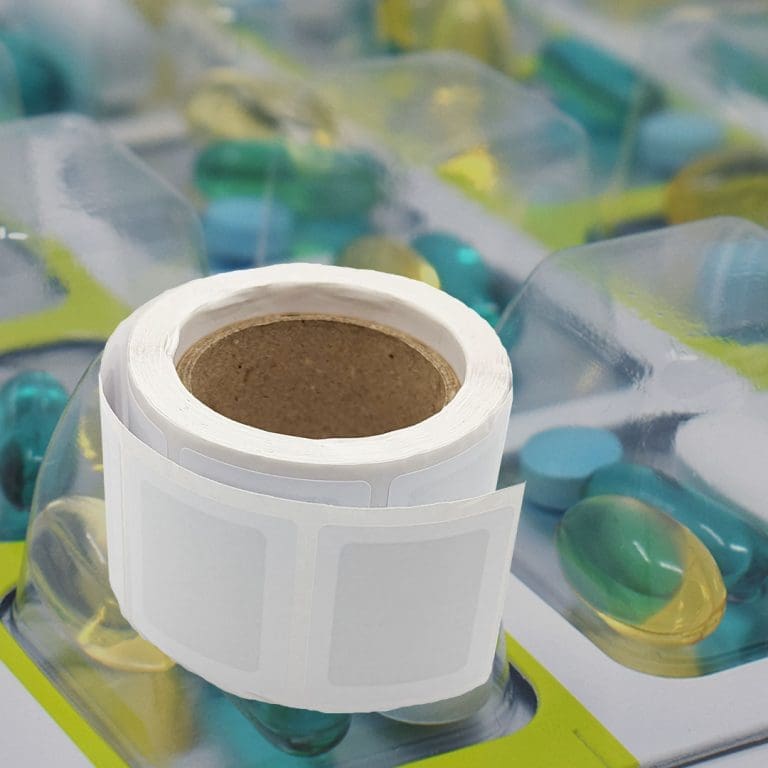 A roll of repair patches resting on a medication blister pack, illustrating how medication management tools are used to maintain the integrity of packaging.